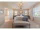 Bedroom features a chandelier, accent furniture, and neutral colors at 5128 Oakhaven Ln, Fort Mill, SC 29708