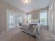 Cozy bedroom features carpet, natural light, neutral walls, and glass paneled doors at 5128 Oakhaven Ln, Fort Mill, SC 29708