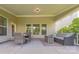 Relaxing covered patio featuring a dining table, sofa, and gas fireplace for enjoying the outdoors at 5128 Oakhaven Ln, Fort Mill, SC 29708