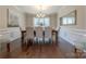 Formal dining room featuring wainscoting, hardwood floors, a chandelier, and ample natural light at 5128 Oakhaven Ln, Fort Mill, SC 29708