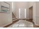 Welcoming foyer with a front door, hardwood floors, a staircase, and a decorative rug at 5128 Oakhaven Ln, Fort Mill, SC 29708
