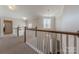 Hallway with white railing overlooks a chandelier and a large window at 5128 Oakhaven Ln, Fort Mill, SC 29708