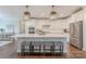 Modern kitchen with a large island, stainless steel appliances, white cabinets, and stylish pendant lighting at 5128 Oakhaven Ln, Fort Mill, SC 29708