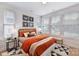 Bright bedroom featuring a large window, stylish decor, and a comfortable bed with orange bedding at 518 Lockwood Creek Dr # 32, Charlotte, NC 28208