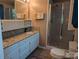 Bathroom featuring granite counters, dual sinks, and a glass enclosed shower stall at 5908 Tanson Trl, Marshville, NC 28103