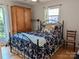 Well-lit bedroom with hardwood floors, a metal bed frame, and a view to the outside at 5908 Tanson Trl, Marshville, NC 28103