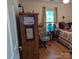 Bedroom featuring hardwood floors, a wooden dresser, an office chair and a cozy bed at 5908 Tanson Trl, Marshville, NC 28103