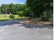 Long paved driveway leading to property with mature landscaping at 5908 Tanson Trl, Marshville, NC 28103