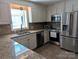 Modern kitchen featuring granite countertops, stainless steel appliances, and ample cabinet space at 5908 Tanson Trl, Marshville, NC 28103