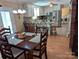 Cozy kitchen featuring white cabinetry, stainless steel appliances, and a breakfast bar adjoining the dining area at 5908 Tanson Trl, Marshville, NC 28103