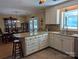 Well-lit kitchen with white cabinets, granite countertops, stainless steel appliances, and breakfast bar at 5908 Tanson Trl, Marshville, NC 28103