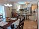 Bright kitchen with white cabinets, stainless steel appliances, and a breakfast bar with seating for four at 5908 Tanson Trl, Marshville, NC 28103