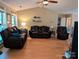 Comfortable living room showcasing hardwood floors and ample seating with three plush leather sofas at 5908 Tanson Trl, Marshville, NC 28103