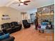 Spacious living room featuring a brick fireplace, hardwood floors, and comfortable leather seating at 5908 Tanson Trl, Marshville, NC 28103
