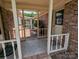 Exterior view of a brick patio with covered seating area, offering a cozy outdoor living space at 5908 Tanson Trl, Marshville, NC 28103