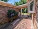 Private brick patio surrounded by lush greenery and flowers, offering a serene outdoor space at 5908 Tanson Trl, Marshville, NC 28103
