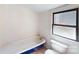 Bathroom featuring a blue claw-foot tub and white fixtures at 600 E 35Th St, Charlotte, NC 28205