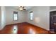 Cozy bedroom with a ceiling fan, windows, and hardwood floors at 600 E 35Th St, Charlotte, NC 28205
