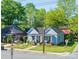 Charming blue home with inviting front porch and well-maintained lawn and shrubs at 600 E 35Th St, Charlotte, NC 28205