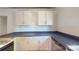 Kitchen featuring bright white cabinets and modern countertops with stainless steel dishwasher at 600 E 35Th St, Charlotte, NC 28205
