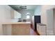 Bright kitchen featuring white cabinets, an island, and hardwood floors at 600 E 35Th St, Charlotte, NC 28205