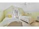 Cozy bedroom with twin beds, bright yellow accents, and a sun-filled window with natural light at 6599 Majestic Pine Dr, Vale, NC 28168