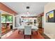 Bright dining room with modern table, stylish chairs, and hardwood floors at 6599 Majestic Pine Dr, Vale, NC 28168