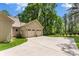 Attached three car garage and driveway with plenty of parking in a lush green setting at 6599 Majestic Pine Dr, Vale, NC 28168