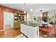 Open kitchen featuring white cabinetry, a kitchen island, and a view of the dining area at 6599 Majestic Pine Dr, Vale, NC 28168