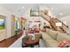Bright, open living room with hardwood floors, staircase, and view of dining area at 6599 Majestic Pine Dr, Vale, NC 28168