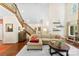 Bright, open living room with hardwood floors, staircase, and a comfortable seating area at 6599 Majestic Pine Dr, Vale, NC 28168