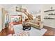 Bright, open living room with hardwood floors, staircase, and view of dining area at 6599 Majestic Pine Dr, Vale, NC 28168