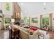 Cozy living room with stone fireplace, plush sofa, and large windows offering scenic views at 6599 Majestic Pine Dr, Vale, NC 28168