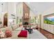 Spacious living room with stone fireplace, large windows, and comfortable seating arrangement at 6599 Majestic Pine Dr, Vale, NC 28168