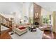 Bright living room featuring a stone fireplace, hardwood floors, and natural light at 6599 Majestic Pine Dr, Vale, NC 28168