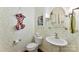 Charming powder room featuring unique wallpaper, pedestal sink, and decorative mirror at 6599 Majestic Pine Dr, Vale, NC 28168
