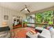 Enclosed porch with comfortable furniture and a serene view of the backyard and adjacent dining space at 6599 Majestic Pine Dr, Vale, NC 28168