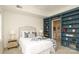 Cozy bedroom with blue built-in bookshelves leading to an ensuite bathroom at 721 Governor Morrison St # 520, Charlotte, NC 28211