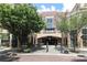 Exterior view of a brick building with trees, outdoor seating, and a covered entrance for the condominiums at 721 Governor Morrison St # 520, Charlotte, NC 28211