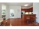 Modern kitchen with cherry cabinets, stainless steel appliances, adjacent to the dining and living areas at 721 Governor Morrison St # 520, Charlotte, NC 28211