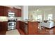 Stylish kitchen with stainless appliances, granite countertops, and an open layout to the living room at 721 Governor Morrison St # 520, Charlotte, NC 28211