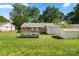 Expansive backyard featuring a wooden deck and storage shed, perfect for outdoor activities and storage at 728 Dedmon Dr, Charlotte, NC 28216