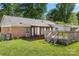 Spacious backyard with a small wood deck, brick exterior, and a screened-in porch at 728 Dedmon Dr, Charlotte, NC 28216