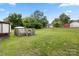 Spacious backyard with lush green grass and a weathered wooden deck at 728 Dedmon Dr, Charlotte, NC 28216