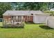 Well-maintained backyard with a wooden deck and storage shed, great for relaxation and outdoor storage at 728 Dedmon Dr, Charlotte, NC 28216