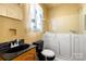 Well-lit bathroom featuring a walk-in bathtub with seat and shower, plus updated fixtures at 728 Dedmon Dr, Charlotte, NC 28216