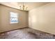 Cozy bedroom with a chandelier fixture and a window for natural light at 728 Dedmon Dr, Charlotte, NC 28216