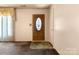 View of the home's entryway, featuring a wooden door with glass insert and neutral walls at 728 Dedmon Dr, Charlotte, NC 28216