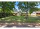 Single-story home with brick accents, light blue siding, and well-maintained lawn with mature trees at 728 Dedmon Dr, Charlotte, NC 28216