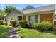 Attractive single-story home featuring a brick facade, white shutters, and meticulously trimmed greenery at 728 Dedmon Dr, Charlotte, NC 28216